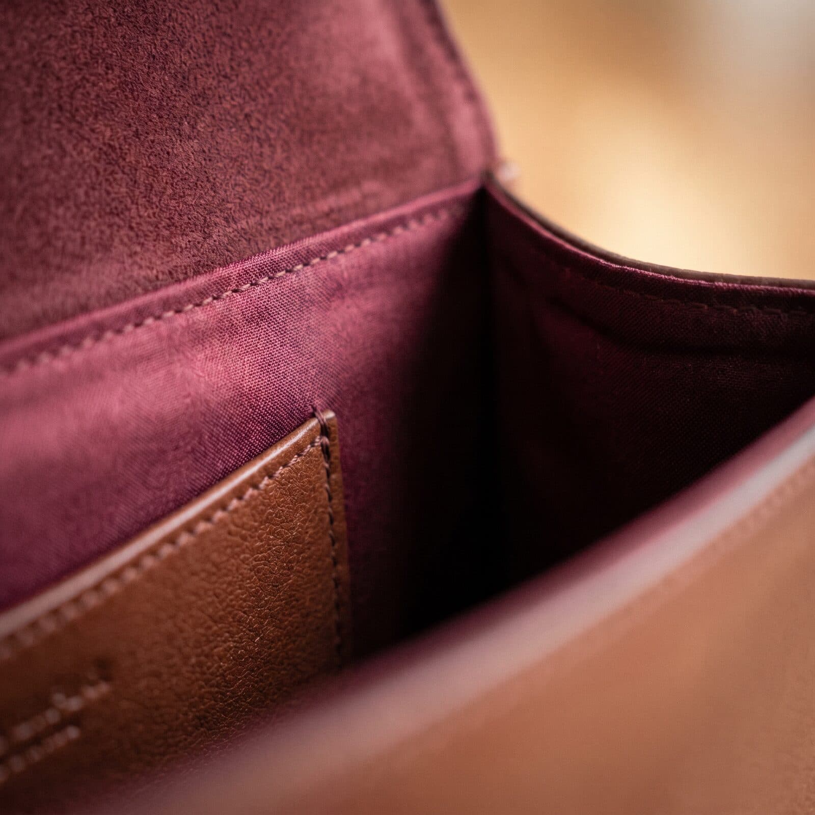Honest corner wear on a pre-owned leather piece — the kind of flaw we photograph and publish before you buy.