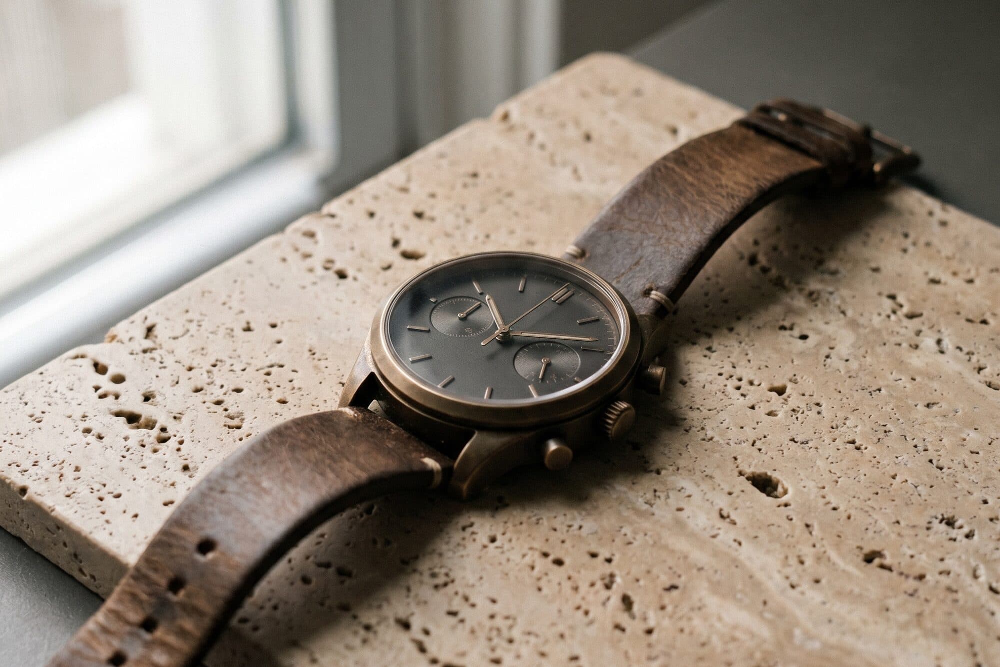 A wristwatch photographed close in warm daylight
